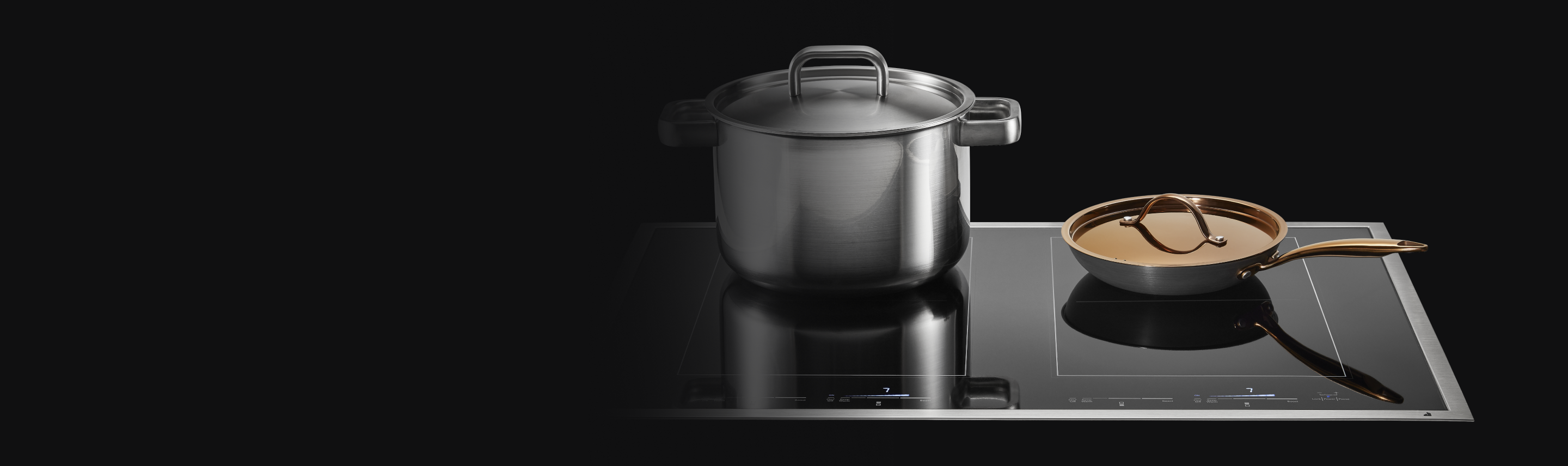 A stockpot and copper pan on a JennAir Induction Cooktop. 